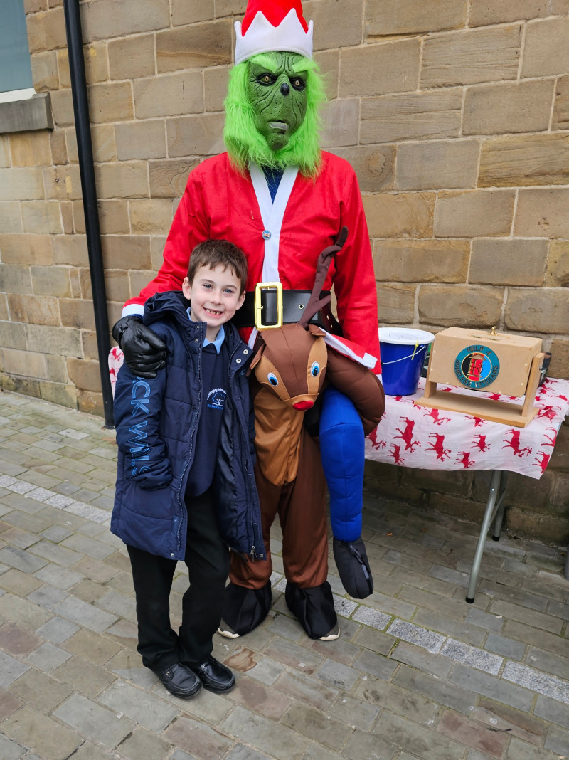 Image for My son with the Grinch, as he becomes too overhelmed/overstimulated at Xmas.