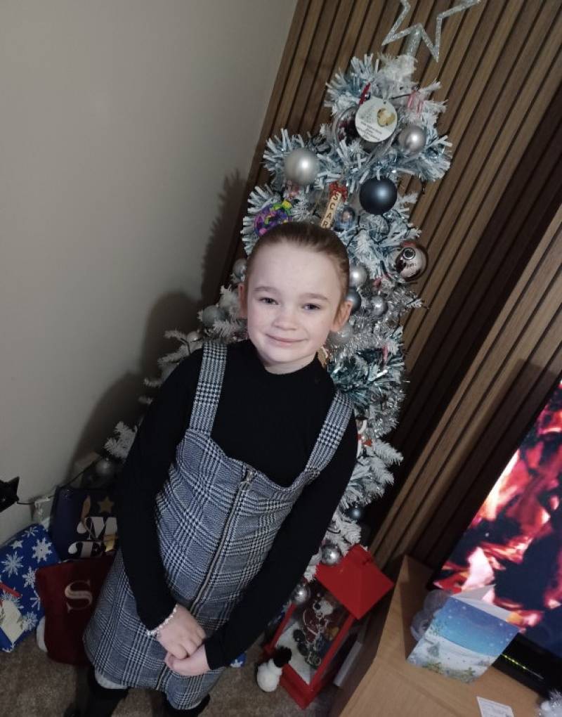 Image for My daughter infront of our christmas tree going to see her great nan  who visited from london