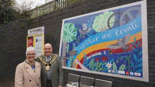 The Mayor and Mayoress of Barnsley, Coun Mick Stowe and his wife Elaine with the new Together We Create mural at Wombwell station.